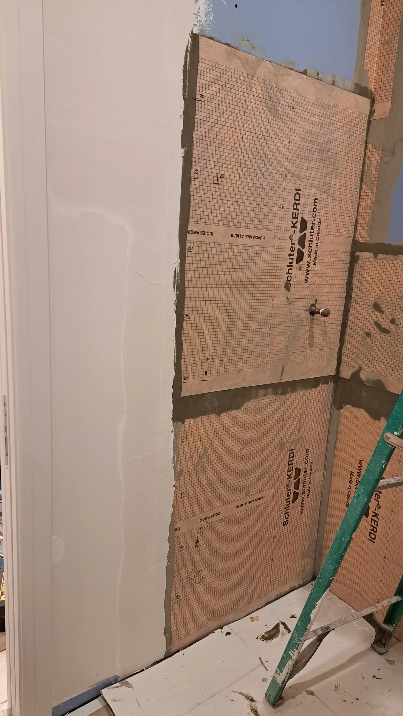 Backer board fastened to a wall during substrate prep, before waterproofing