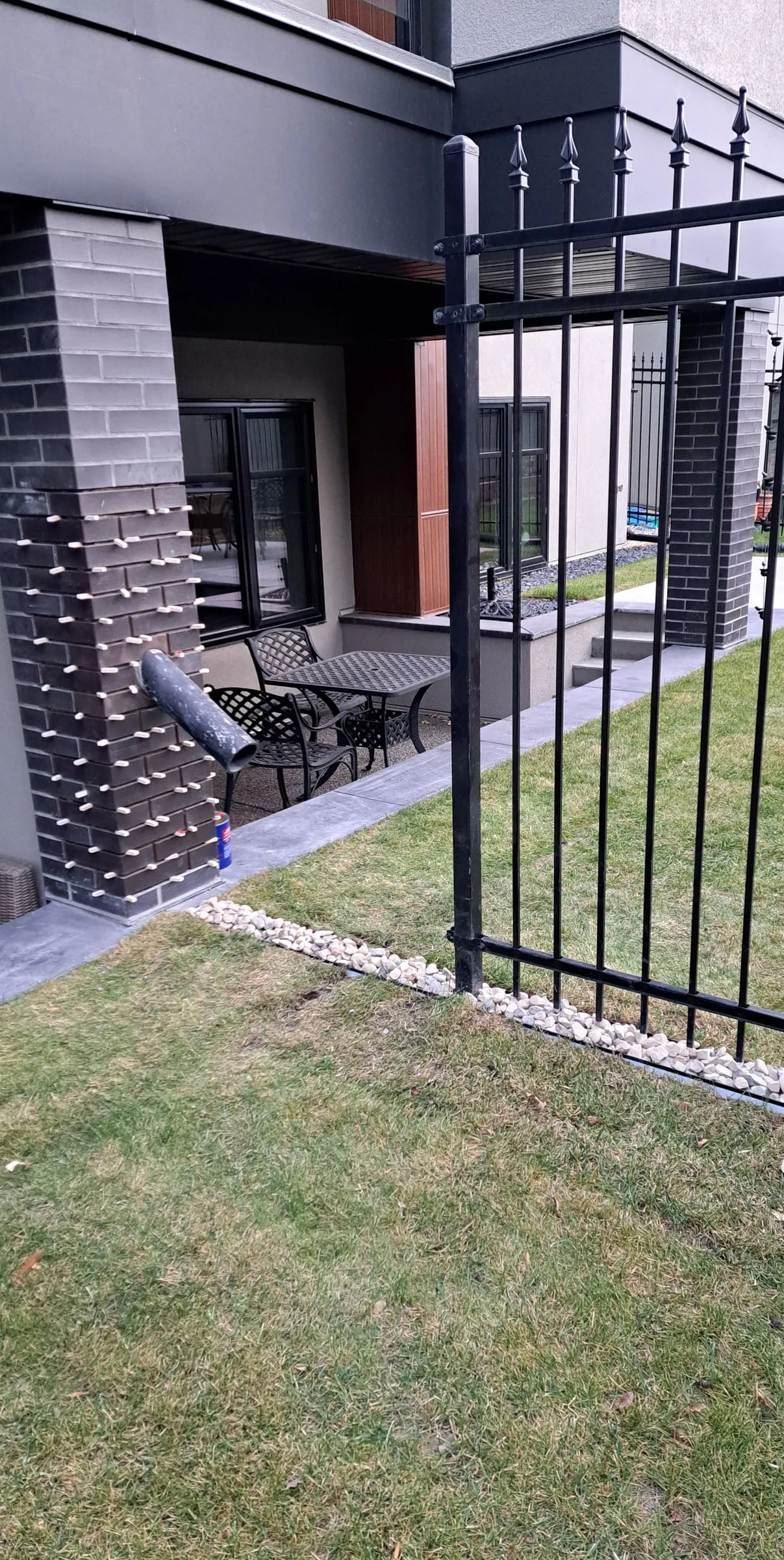 Exterior of a home with stone and brick cladding facing the yard