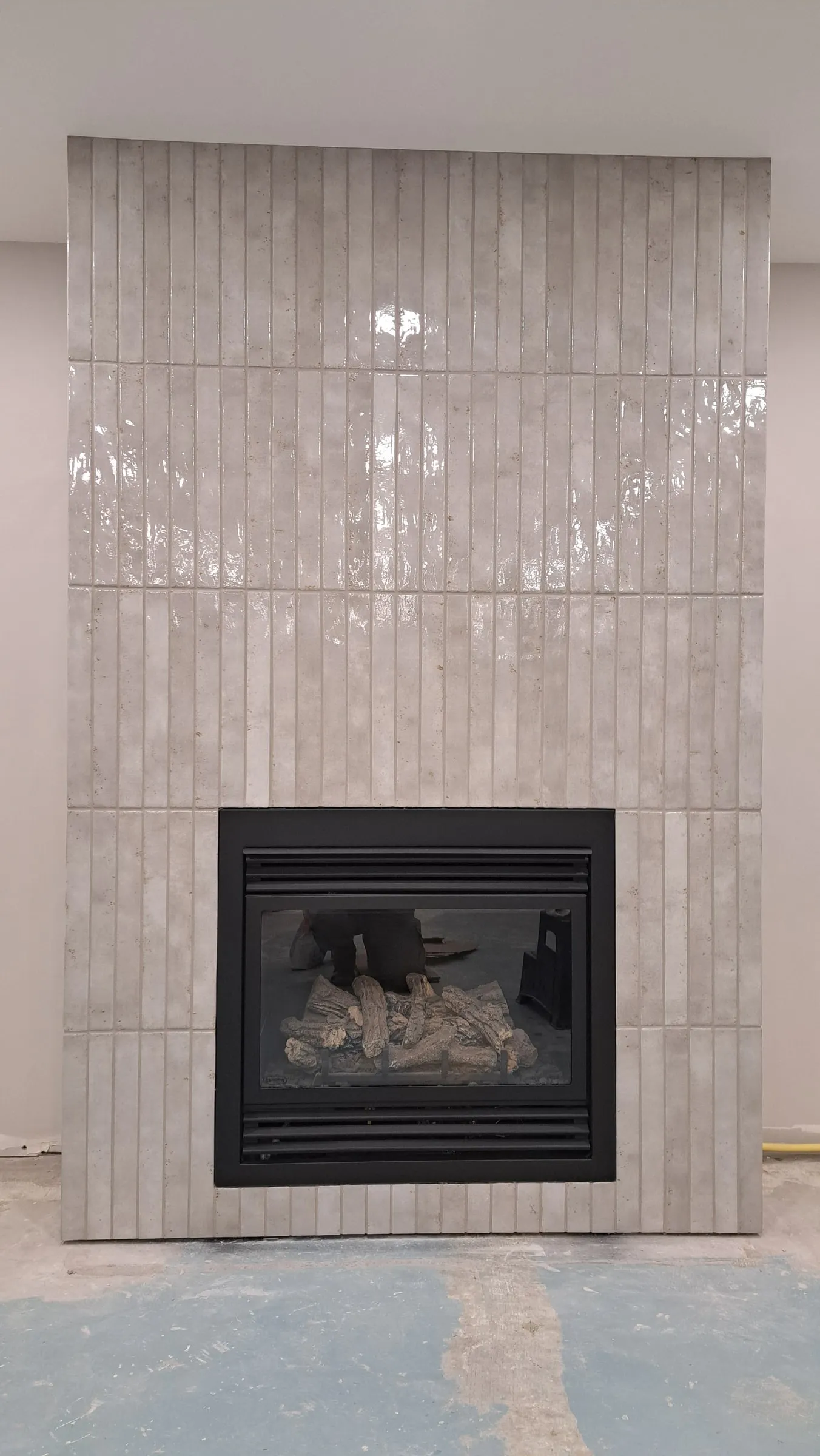 Finished fireplace surround in vertical stacked tile
