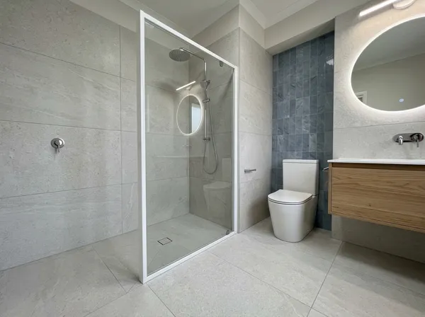 Full bathroom renovation by VitalTile & Stone — Large-format porcelain · Schluter waterproofing · epoxy grout