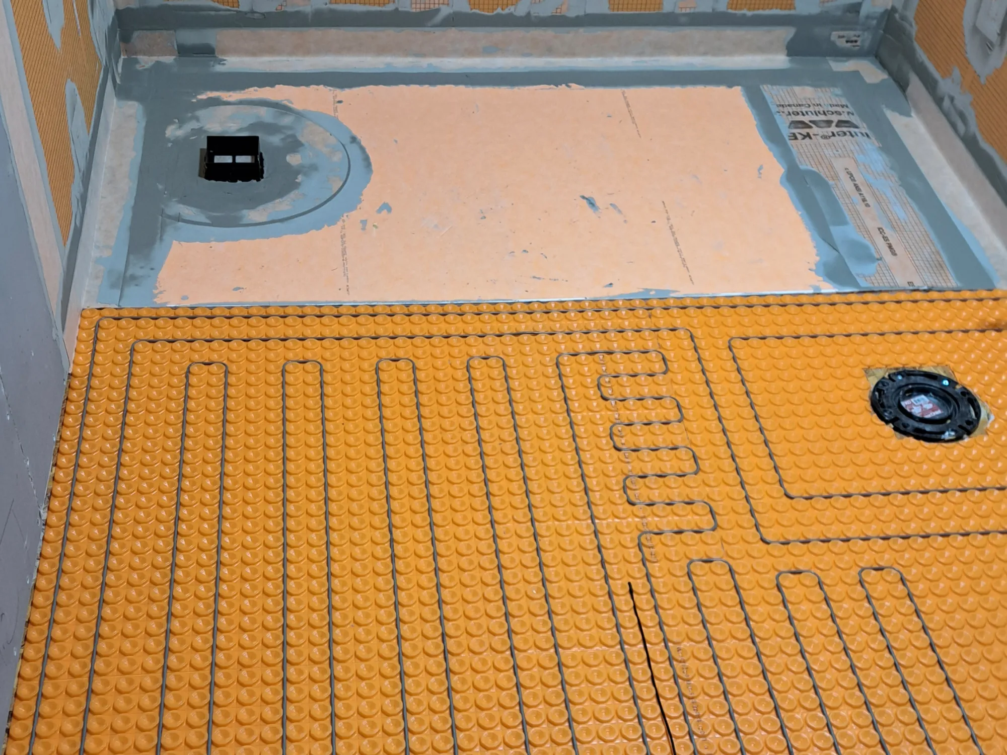 Electric heated floor mat under 24×24 porcelain tile, Calgary